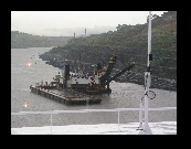 This crane is dredging the Culebra Cut and dumping the sludge in the barge. This part of the canal was the major construction feat of the canal project.